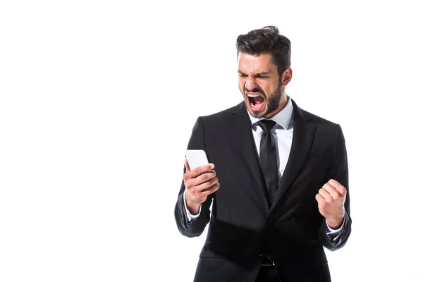 Urlando uomo d'affari con smartphone e mano serrata isolato su bianco — Foto stock