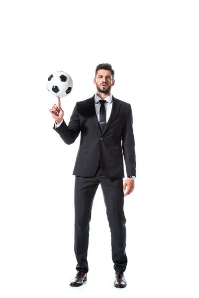 Bel homme d'affaires en tenue formelle filature ballon de football sur doigt isolé sur blanc — Photo de stock