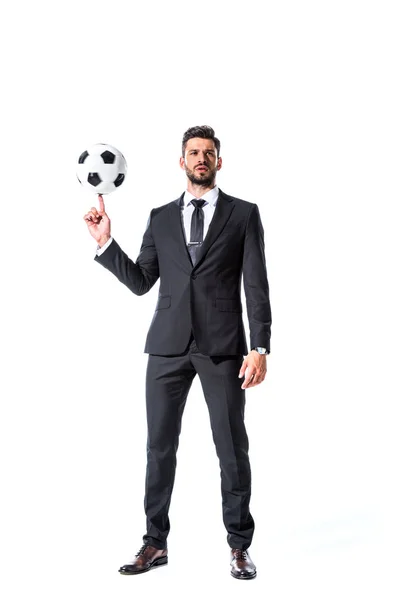 Handsome businessman in formal wear spinning soccer ball on finger Isolated On White — Stock Photo