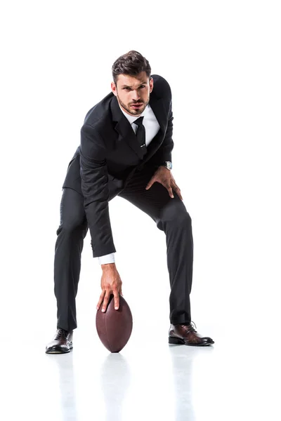 Homme d'affaires en tenue formelle avec ballon de rugby sur blanc — Photo de stock