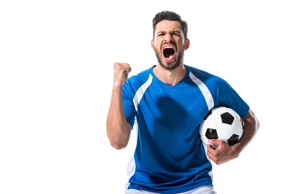 Jogador de futebol animado com bola e mão apertada gritando isolado no branco — Fotografia de Stock