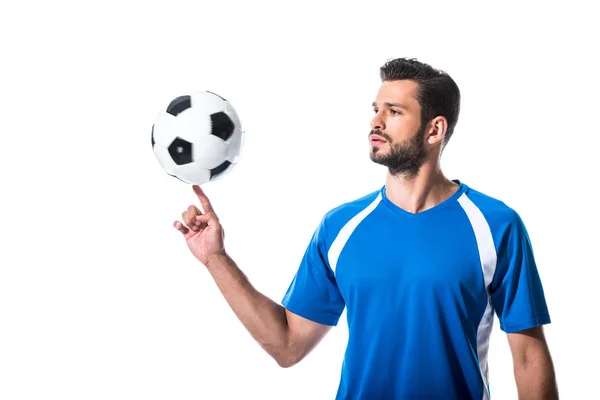 Jugador de fútbol girando en la bola de dedo aislado en blanco - foto de stock