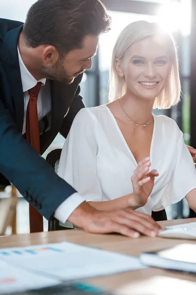 Selective focus of handsome man looking at happy blonde woman — Stock Photo