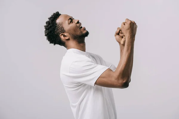 Upset bearded african american man with clenched fists isolated on grey — Stock Photo