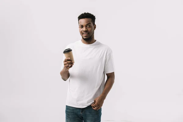 Curly african american man holding paper cup isolated on white — Stock Photo