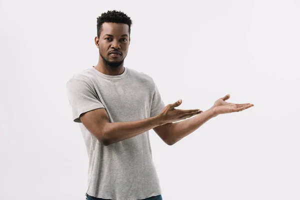 Handsome african american man gesturing while looking at camera isolated on white — Stock Photo