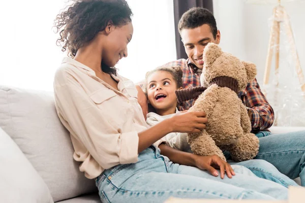 African american mother holding teddy bear while kid looking at mom — Stock Photo