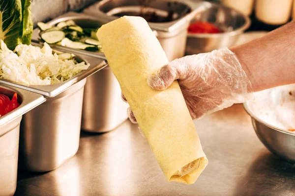 Partial view of cook holding doner kebab at table — Stock Photo