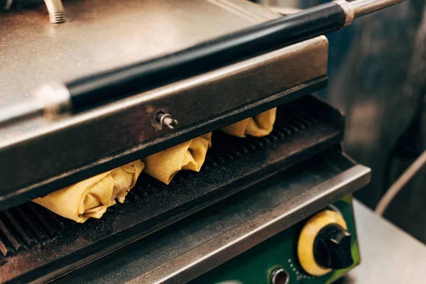 Selective focus of doner kebabs preparing in kebab grill — Stock Photo