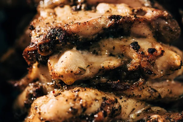 Close up view of delicious meat on rotisserie isolated on black — Stock Photo