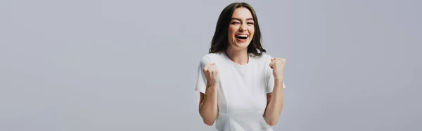 Shocked happy beautiful girl in white t-shirt touching face isolated on grey — Stock Photo