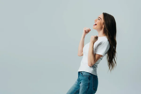 Side view of happy beautiful girl in white t-shirt showing yes gesture isolated on grey — Stock Photo