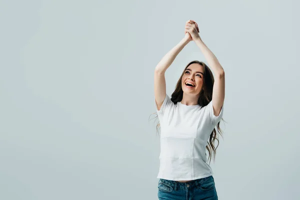 Glücklich schönes Mädchen in weißem T-Shirt mit betenden Händen isoliert auf grau — Stockfoto