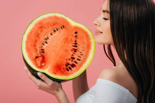 Beautiful smiling girl with closed eyes holding ripe delicious watermelon half isolated on pink — Stock Photo