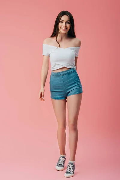 Full length view of smiling girl isolated on pink — Stock Photo