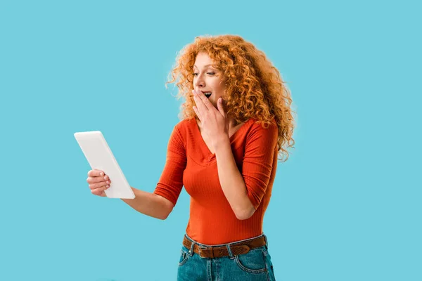 Überraschte Frau mit digitalem Tablet isoliert auf blau — Stockfoto