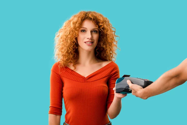 Redhead woman paying with credit card on terminal, Isolated On blue — Stock Photo