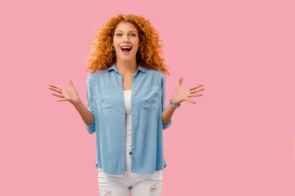 Attractive excited redhead woman gesturing Isolated On pink — Stock Photo