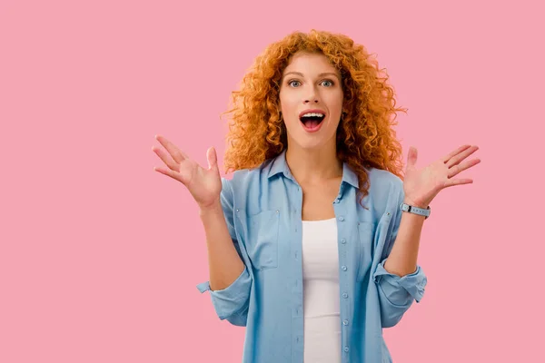 Attractive surprised redhead woman isolated on pink — Stock Photo