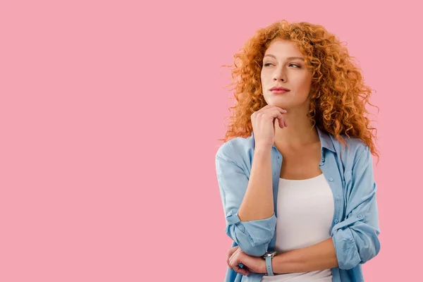 Attractive thoughtful young woman isolated on pink — Stock Photo