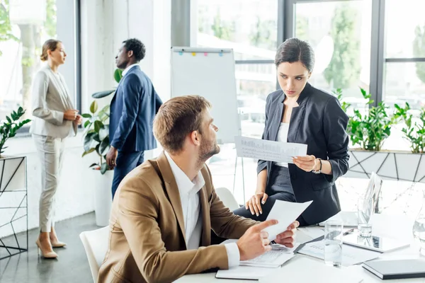 Multiethnic businesspeople in formal wear at conference in office — Stock Photo