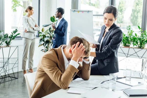 Multiethnic businesspeople in formal wear at conference in office — Stock Photo