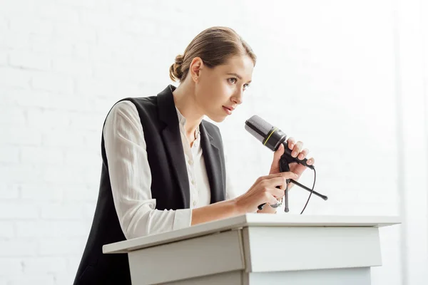 Привлекательная деловая женщина, стоящая и разговаривающая во время конференции в конференц-зале — стоковое фото