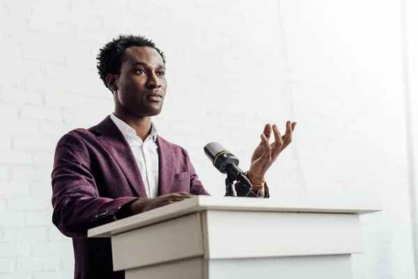 African american businessman in formal wear talking during conference — Stock Photo