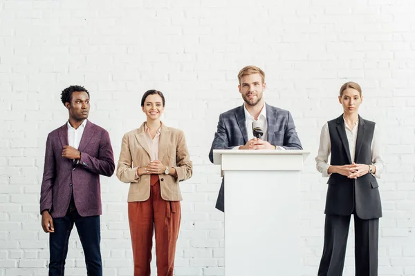 Businessman in formal wear talking during conference in conference hall — Stock Photo