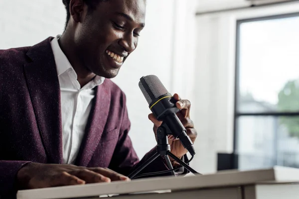 African american businessman in formal wear smiling during conference — Stock Photo