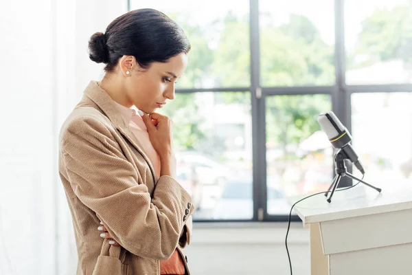 Side view of attractive and thoughtful businesswoman in formal wear — Stock Photo