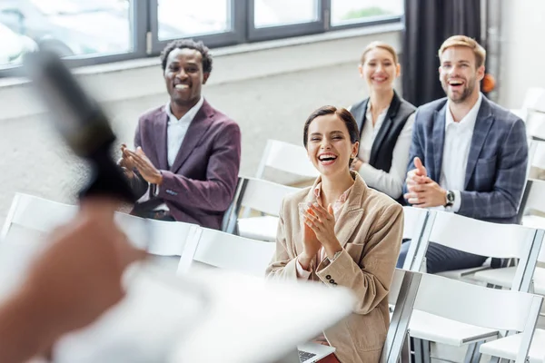 Four multiethnic colleagues in formal wear clapping during conference — Stock Photo