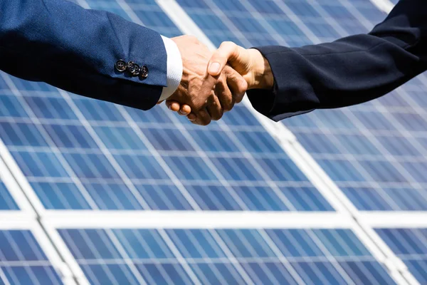 Cropped view of businessman and businesswoman shaking hands outside — Stock Photo