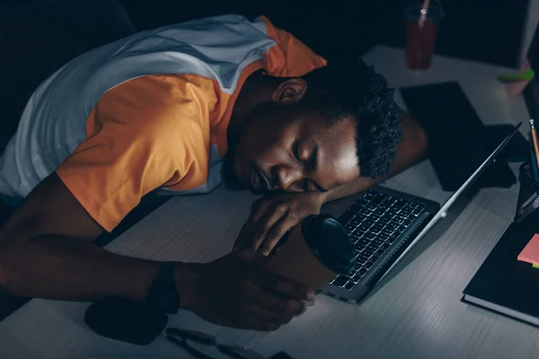 Tired african american programmer sleeping on keyboard in office — Stock Photo