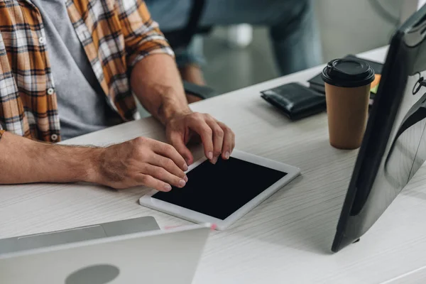 Cropped view of programmer using digital tablet while sitting at workplace — Stock Photo