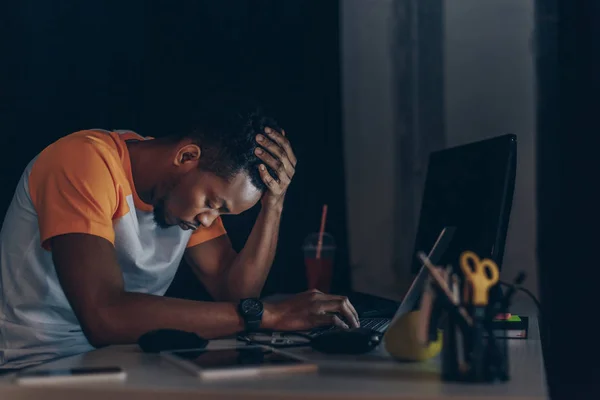Sleepy african american programmer sitting at workplace with closed eyes — Stock Photo