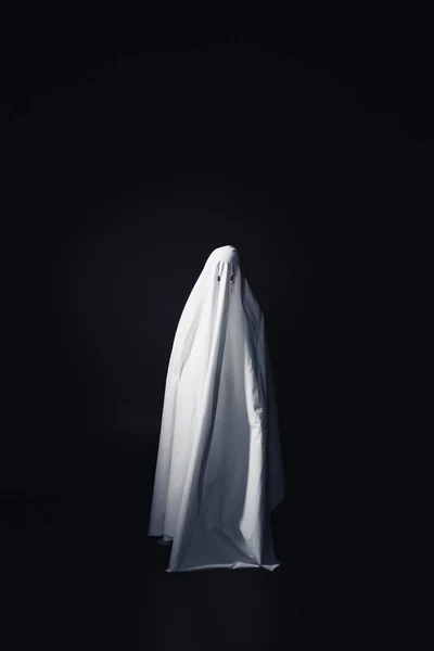 Horrible ghost in white bedsheet isolated on black with copy space — Stock Photo