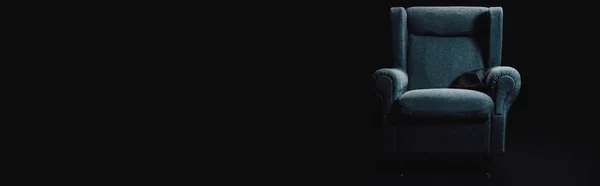 Panoramic shot of grey armchair isolated on black with copy space — Stock Photo