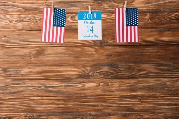 Kalender mit 14 Oktober Datum zwischen amerikanischen Nationalflaggen auf hölzerner Oberfläche — Stockfoto