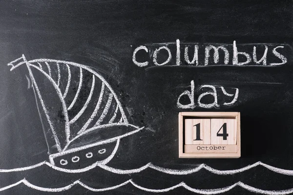 Wooden calendar with October 14 date on chalkboard with ship drawing and Columbus Day inscription — Stock Photo