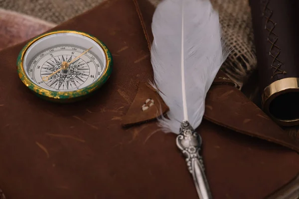 Nib and compass on leather copy book on hessian — Stock Photo