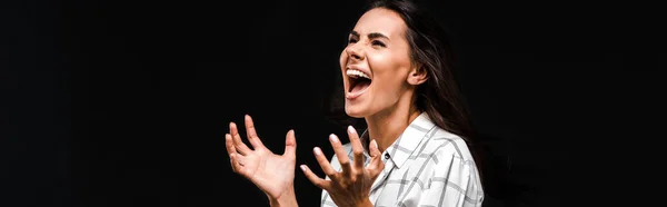 Panoramic shot of woman screaming and gesturing isolated on black — Stock Photo