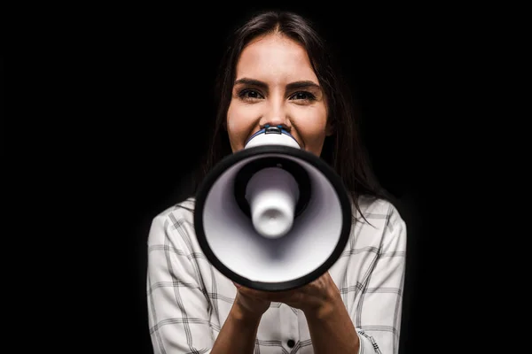 Cheerful woman holding megaphone isolated on black — Stock Photo