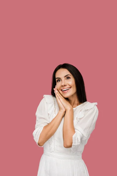 Happy and dreamy woman in white dress isolated on pink — Stock Photo