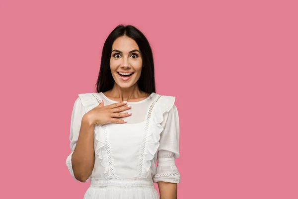 Excited girl in white dress looking at camera isolated on pink — Stock Photo