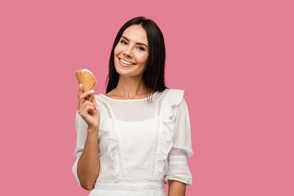 Happy woman in dress holding ice cream cone isolated on pink — Stock Photo