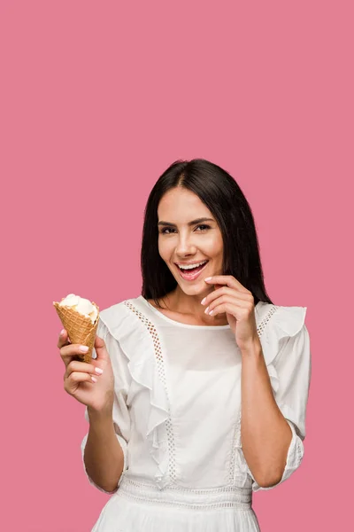 Mujer alegre en vestido sosteniendo cono de helado aislado en rosa - foto de stock