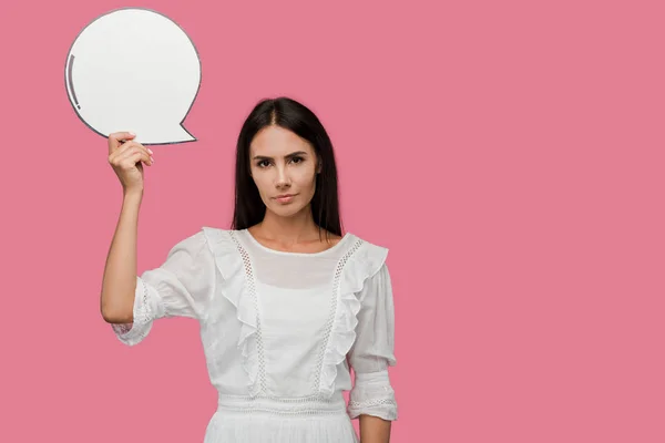 Mujer joven sosteniendo burbuja discurso en blanco aislado en rosa - foto de stock