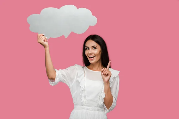 Happy girl holding thought bubble and gesturing isolated on pink — Stock Photo