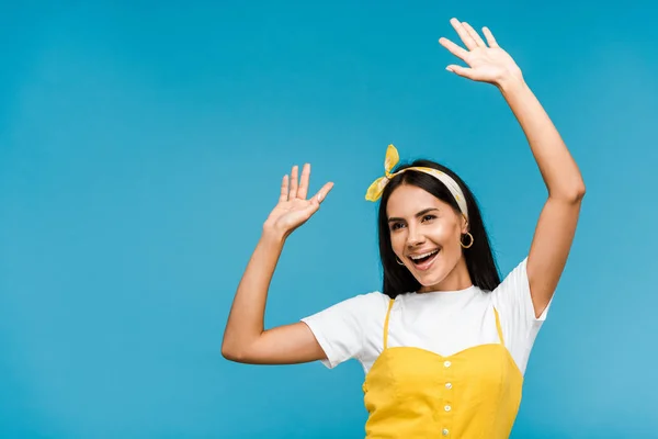 Happy young woman in headband gesturing isolated on blue — Stock Photo